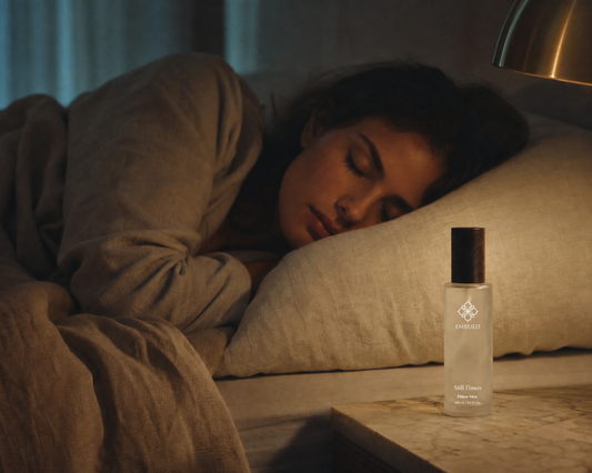 erson resting peacefully beside a sleep spray bottle on bedside table — what is aromatherapy for sleep